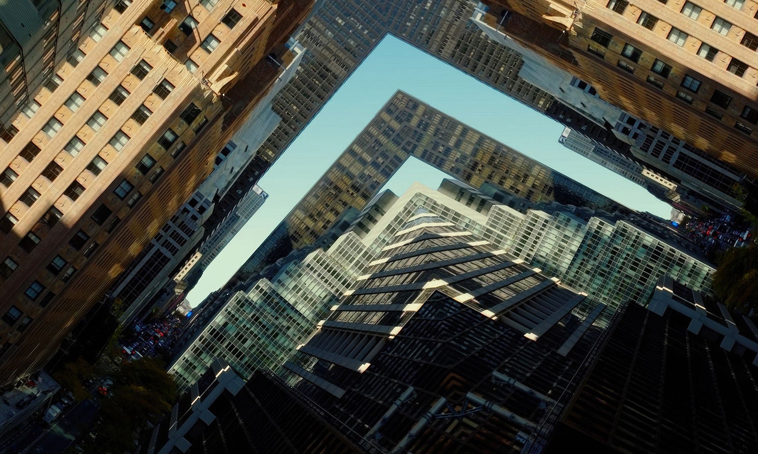 高层建筑的鸟瞰图，众多高楼之间形成一个 L 形间隙，勾勒出棱角分明的天际线，凸显城市的密度与几何之美。